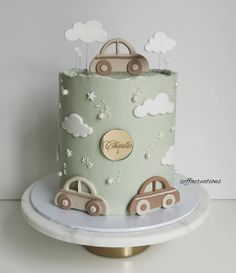 a green cake with cars and clouds on it