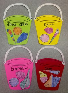 four buckets with names painted on them