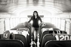 a woman is sitting on the back of a bus