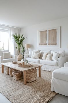 a living room filled with white furniture and pillows