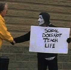 two people dressed in costumes holding signs and shaking hands