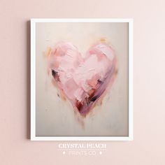 a heart shaped painting on a pink wall above a white frame with the words crystal peach print's co written below it