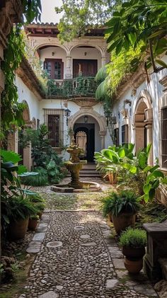 an old courtyard with potted plants and stone walkway