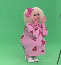 a woman dressed in pink is talking on the phone