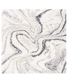 a white rug with black and grey swirls on the bottom, in an abstract pattern