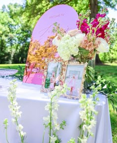 a table with flowers and pictures on it