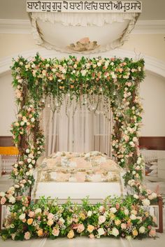 the bed is decorated with flowers and greenery