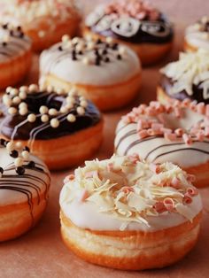 there are many donuts that have sprinkles on them and frosting