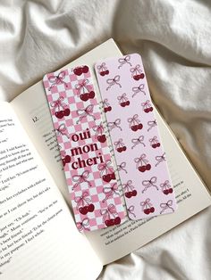 🎀 Oui mon cheri bookmark set 💘 Cherry, bows and ribbons themed 💌 Perfect for romance readers  Bookmark Details: - Bookmark dimensions: 19cm x 5.5cm (approx) - Printed in London on 300gsm textured matte card stock - Bookmarks are available with and without tassels  - Tassel colours varies - Curved edge detail - Blank at the back How To Order: - Select between with or without a tassel!  Shipping Details UK: As our products are made to order on a small scale, please allow 1-3 days for production, in addition to 2-3 working days for postage via Royal Mail. The total expected time frame is approximately 1 week (7 working days excluding weekends). - Shipping from UK is 2-3 business days via 2nd class royal mail Shipping Details International: Please be aware that the shipping time frames disp Romance Reader, Creative Bookmarks, Cute Bookmarks, Diy Bookmarks, Romance Readers, Book Art Diy, Mon Cheri, Bookmarks Handmade, Bookish Gifts