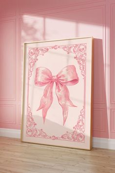 a pink bow is hanging on the wall