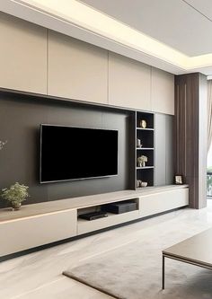 a large flat screen tv mounted to the side of a wall in a living room