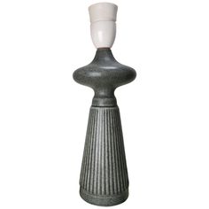 a gray and white vase sitting on top of a table