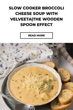 a white bowl filled with cheese soup next to some slices of bread on a plate