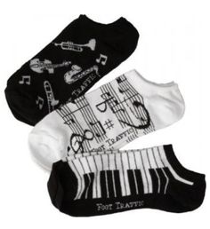 three pairs of socks with musical instruments on them