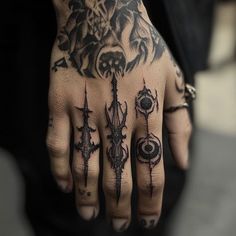 a hand with some tattoos on it