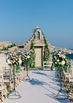 an outdoor ceremony setup with flowers and candles