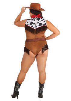 a woman in a cowgirl costume is posing for the camera with her hands on her hips