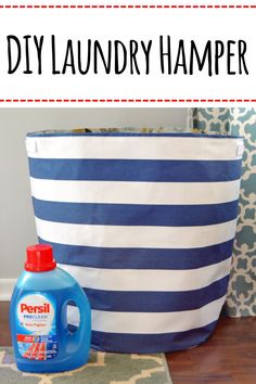 a laundry hamper sitting on top of a wooden floor next to a blue and white bag