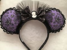 a close up of a mouse ears headband on a white surface with black lace