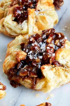 several pastries with toppings sitting on top of each other