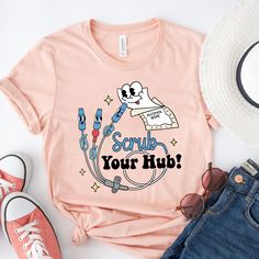 a t - shirt that says scrub your hub on it next to sunglasses and hat