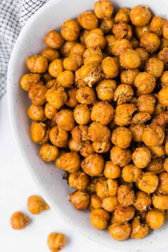 a white bowl filled with chickpeas on top of a table