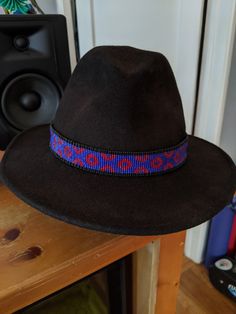 This hat band is made to order and will take approximately 1-3 weeks to create (please message me if you need an exact time frame). All hat bands are created on a loom and handwoven by me. Hat bands are finished with faux leather, deerskin ties, and pewter beads. Approximate width is 1 inch. When checking out, please provide the measurement of your hat so I can ensure appropriate fit.  Colors may be interchanged, and custom requests are welcome. Due to the handmade nature of the process, individ Traditional Handmade Wide Brim Fedora, Handmade Fedora With Flat Crown For Festivals, Handmade Flat Crown Fedora For Festivals, Traditional Handmade Fedora With Short Brim, Handmade Curved Brim Hat Band For Country Events, Handmade Flat Crown Hats For Festivals, Handmade Short Brim Costume Hats For Country Events, Handmade Flat Brim Costume Hat For Country Events, Traditional Adjustable Felt Hat With Curved Brim