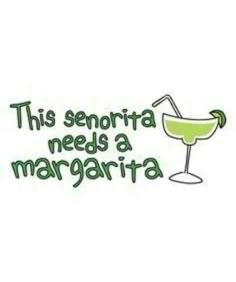 a green margarita sitting on top of a white table next to a sign that says, this