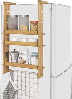 a wooden shelf with some items on it and a towel hanging from the bottom, in front of a refrigerator