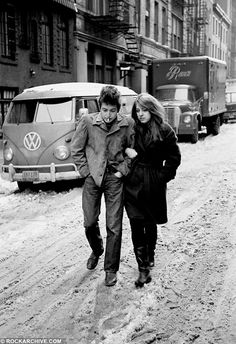 two people walking down a snow covered street