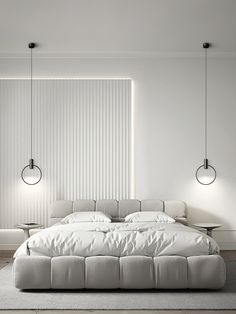 a large white bed sitting in a bedroom next to two lamps on either side of it