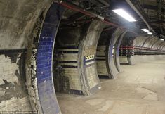 an underground tunnel with blue and white tiles