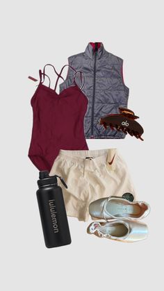 the contents of a woman's outfit including shoes, water bottle and sports bra