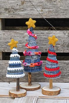 three knitted christmas trees with stars on them