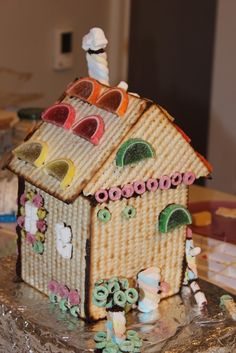 a gingerbread house made to look like it has fruit on top