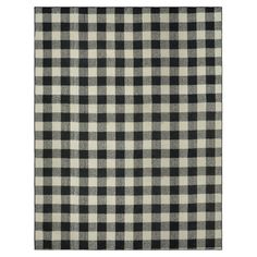 a black and white checkered rug on a white background with an area rug in the middle