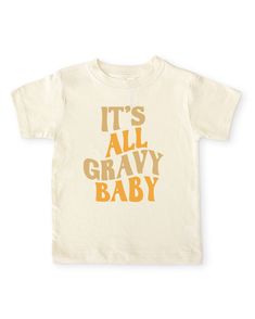 A fun, retro kids shirt for fall and Thanksgiving. Features an alternating tan and mustard yellow "it's all gravy baby" retro wavy text on our cozy gender neutral toddler crew neck tee. Made from buttery-soft airlume cotton that provides all day comfort, breathability and flexibility for all activity levels. ☑ 100% combed ringspun airlume cotton☑ Buttery-soft, light-weight & breathable material☑ Unisex fitted short sleeve crew neck ☑ Flatlock seams to eliminate friction☑ Double-needle ribbed bin Cream Graphic T-shirt For Fall, Cream Graphic Print T-shirt For Fall, Cream Short Sleeve T-shirt For Fall, Kids Vinyl Shirt Ideas, Toddler Shirt Ideas, Thanksgiving Shirts For Kids, Kids Thanksgiving Shirts, Toddler Tshirt Ideas, Toddler Thanksgiving Shirt