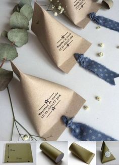 some paper cones are sitting on the table with flowers and leaves next to each other