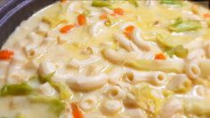 a bowl filled with pasta and vegetables on top of a table