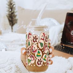 a person holding a cup with some decorations on it