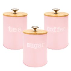 three pink canisters with wooden lids and the words sugar written on each one