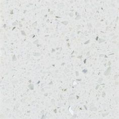 a white counter top with small pieces of glass on it