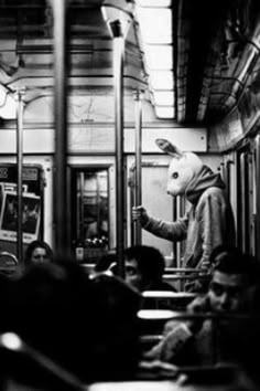 people are sitting on the subway train and looking at their phones