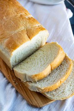 a loaf of bread sitting on top of a wooden cutting board