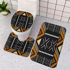 two bathroom rugs on the floor in front of a toilet and tiled wall behind them