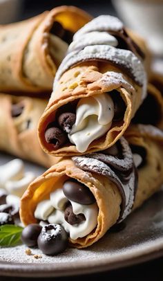 chocolate and cream filled crepes on a plate