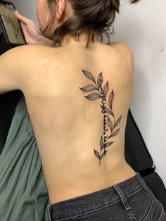 a woman with a tattoo on her back