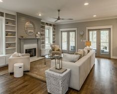 a living room filled with furniture and a fire place in the middle of a room