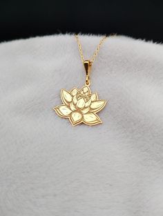 Embrace the serene beauty of our Dainty Lotus Flower Necklace, a delicate piece crafted in exquisite 14K gold. This enchanting accessory features an intricately engraved lotus charm, symbolizing purity and enlightenment. Perfect for the minimalist at heart, this necklace adds a touch of elegance to any ensemble while serving as a thoughtful reminder of tranquility and inner peace. Ideal for yoga enthusiasts and meditation practitioners, this piece seamlessly blends spirituality with style. ⭐ Pac Spiritual Gold Flower Necklaces, Lotus Locket Gold, Gold Lotus Flower Jewelry For Gift, Elegant Lotus Flower Jewelry Gift, Spiritual Lotus Flower Necklace Gift, Lotus Flower Necklace, Yoga Lover Gift, Gold Earrings Models, Lotus Necklace