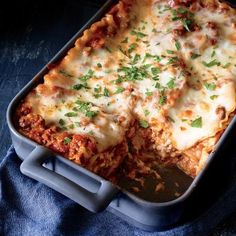 a lasagna casserole with meat and cheese is shown in a pan